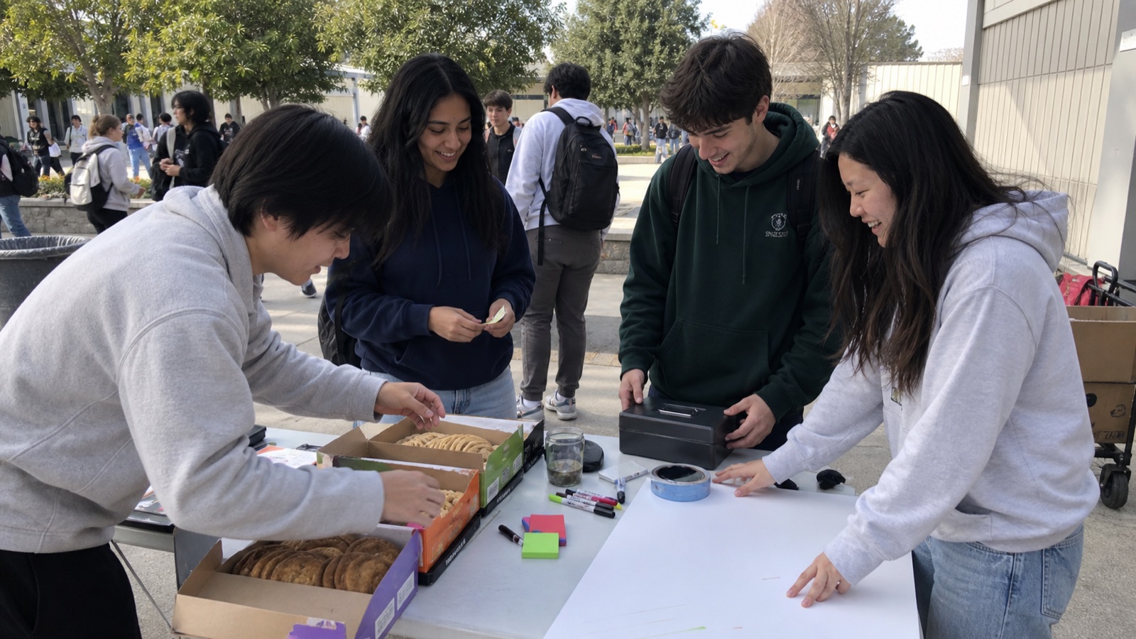 Students setting up an outdoor fundraiser table