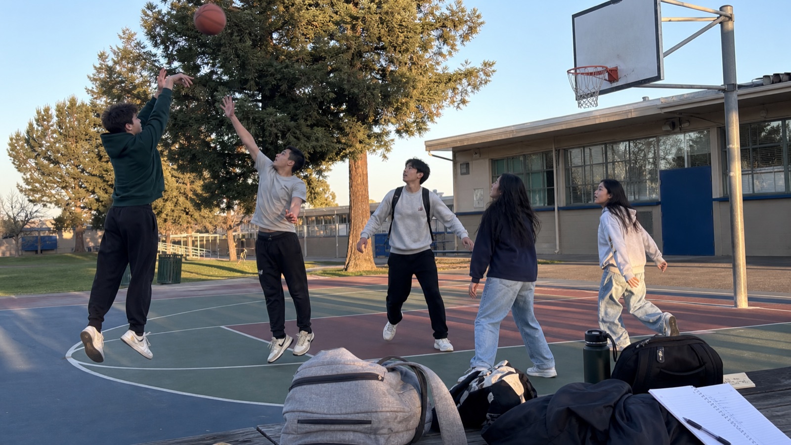 Students playing basketball outside after a club meeting