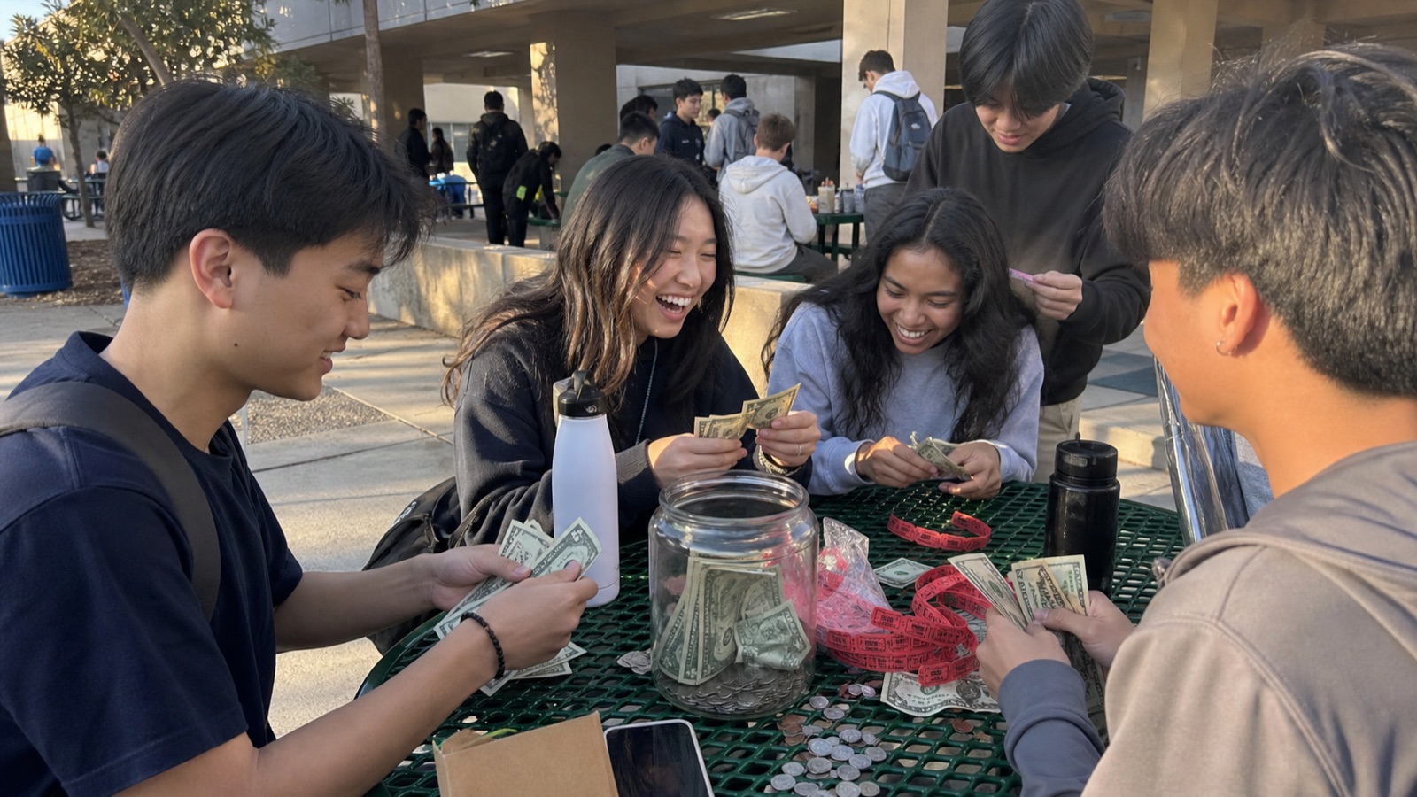 Students counting fundraiser tickets and small donations