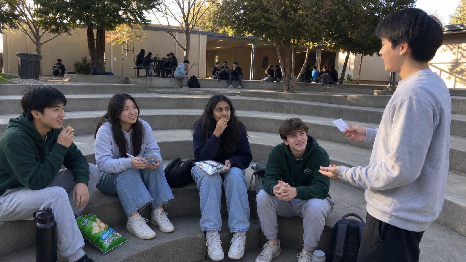 Students practicing a short pitch in an outdoor amphitheater